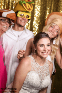 Bride and guests taking pictures in a Dow Oak Events’ open-air photo booth.